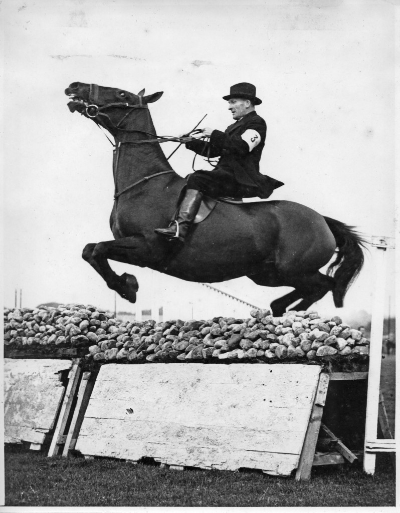 Fr. Tom clearing a wall during a hunt with the Galway Blazers